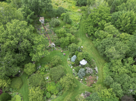 Arial view of a garden surrounded by dense tree growth.
